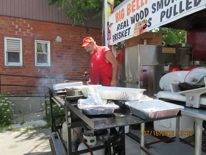 Pitmaster preparing food near the truck